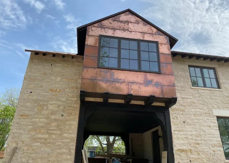 Copper metal panel facade on a stone building for Skylight Installation in Jacksonville Beach