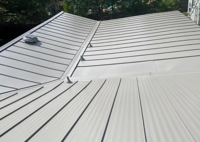Solar attic fan installed on a metal roof for Roof Ventilation in Jacksonville Beach